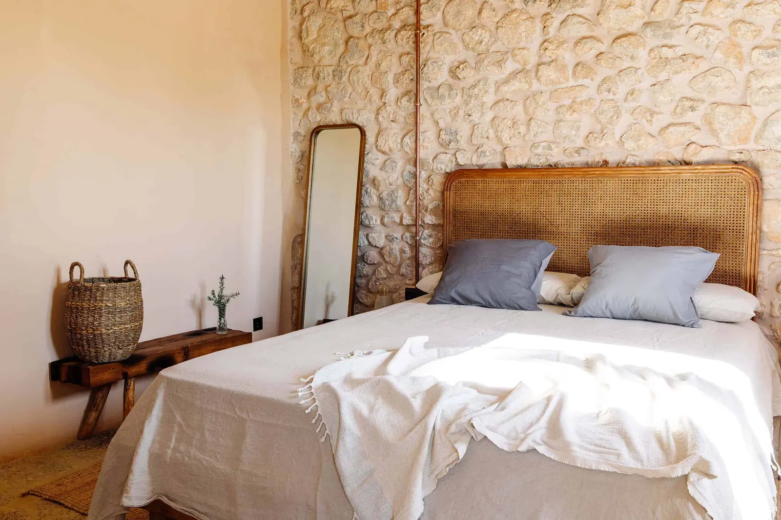 Casa Mana garden-view double room — calm and simply furnished, with doors to the outdoor spaces